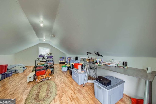 interior space with vaulted ceiling and light hardwood / wood-style flooring