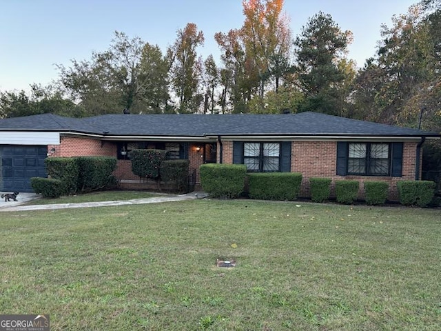 ranch-style house with a garage and a front lawn