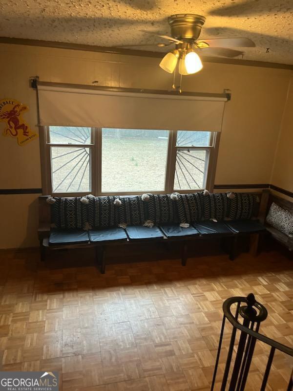 unfurnished room featuring ceiling fan and a textured ceiling