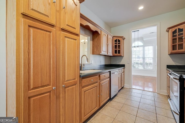 kitchen featuring light tile patterned floors, appliances with stainless steel finishes, and sink