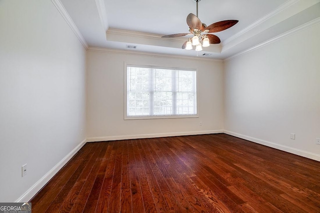 spare room with hardwood / wood-style flooring, a tray ceiling, ornamental molding, and ceiling fan