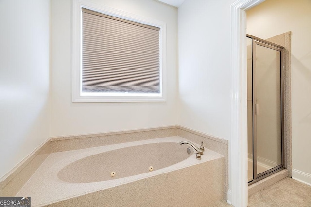 bathroom featuring plus walk in shower and tile patterned flooring