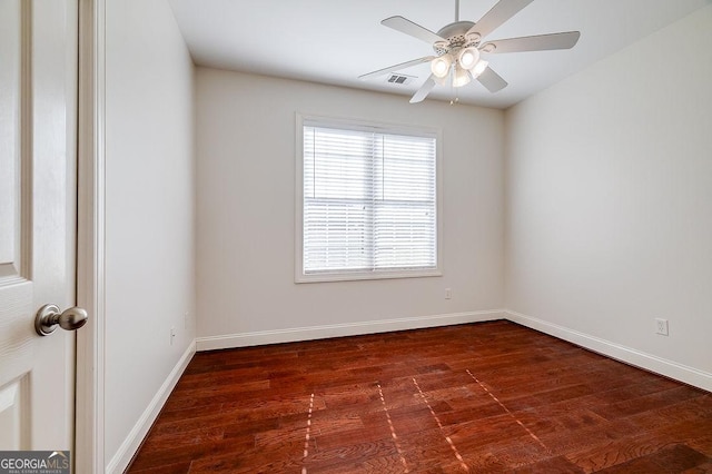 unfurnished room featuring ceiling fan and dark wood-type flooring