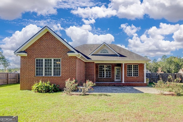 view of front of home with a patio area and a front yard