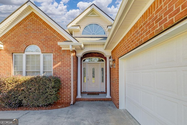 view of exterior entry with a garage