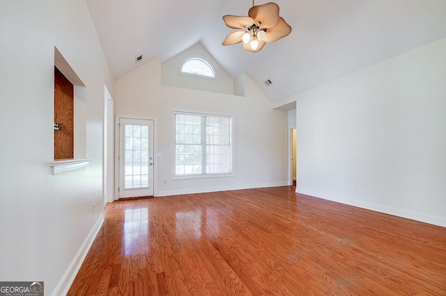 unfurnished room with ceiling fan, wood-type flooring, and high vaulted ceiling