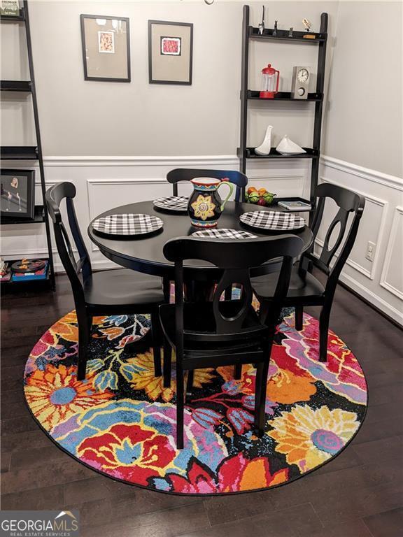 dining area with dark hardwood / wood-style flooring