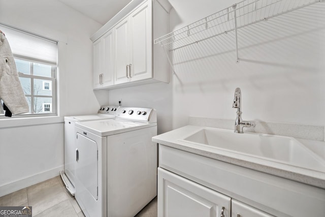 laundry room with separate washer and dryer, sink, light tile patterned floors, and cabinets