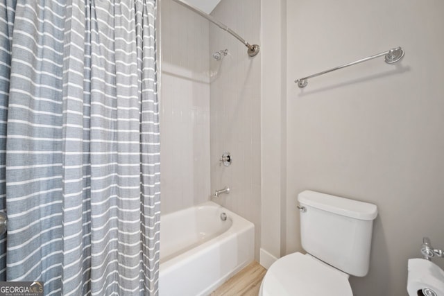 bathroom with wood-type flooring, shower / bath combo with shower curtain, and toilet