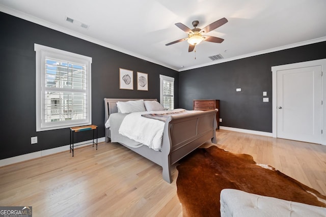 bedroom with ceiling fan, ornamental molding, and light wood-type flooring