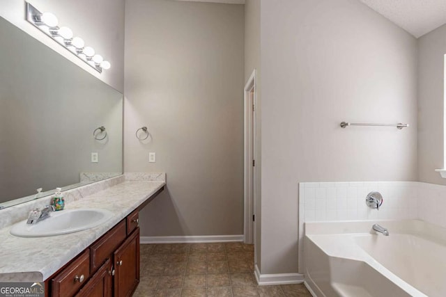 bathroom featuring a bath and vanity