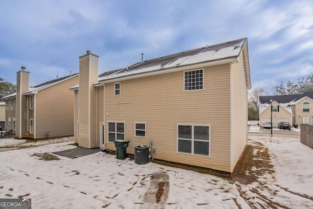 rear view of house with central AC unit