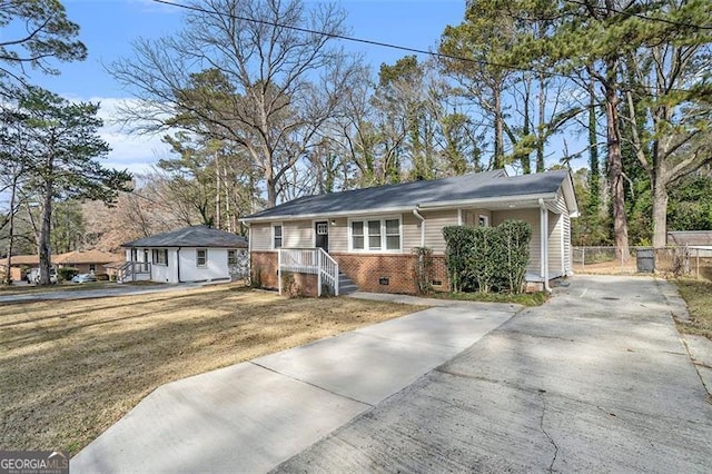 ranch-style home with a front lawn