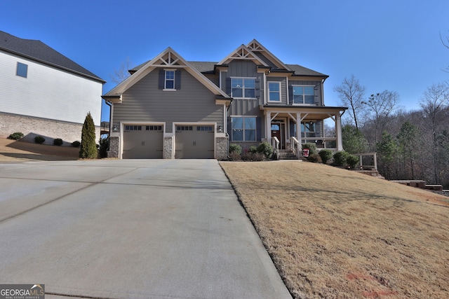 view of front facade featuring a garage, a porch, and a front lawn