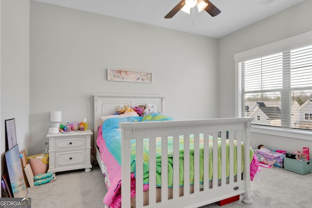 carpeted bedroom featuring ceiling fan