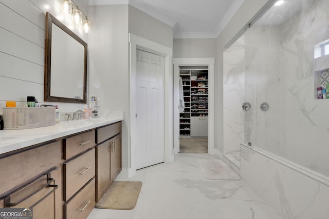 bathroom with vanity, tiled shower, and ornamental molding