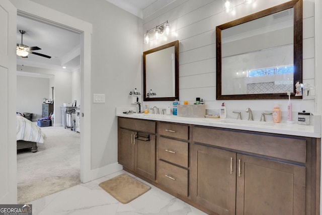 bathroom with ceiling fan, ornamental molding, and vanity