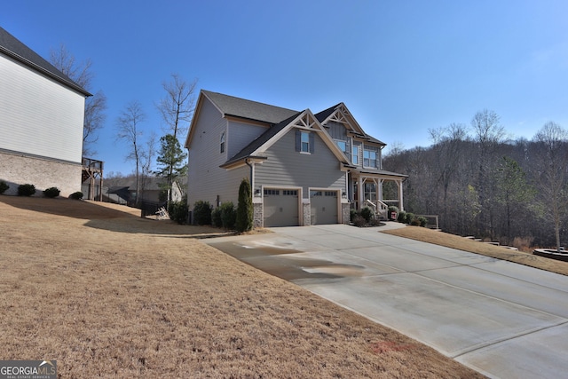 exterior space featuring a garage, covered porch, and a front lawn