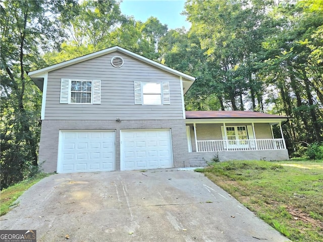 view of front of property featuring covered porch and a garage