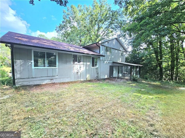 back of property featuring a yard