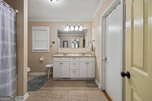 bathroom with a textured ceiling, vanity, crown molding, and tile patterned flooring