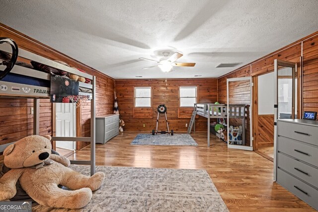 bedroom featuring a textured ceiling and light hardwood / wood-style flooring