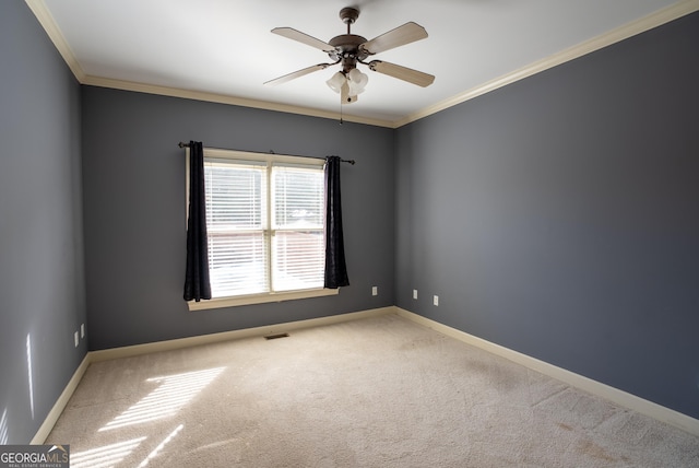 spare room featuring ceiling fan, light carpet, and crown molding