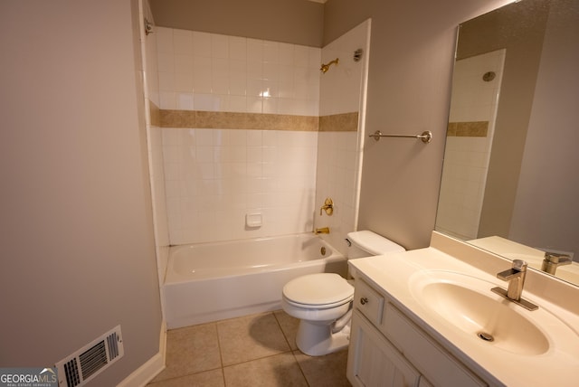 full bathroom featuring toilet, tiled shower / bath, tile patterned flooring, and vanity