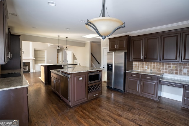 kitchen featuring tasteful backsplash, pendant lighting, an island with sink, stainless steel appliances, and dark brown cabinets