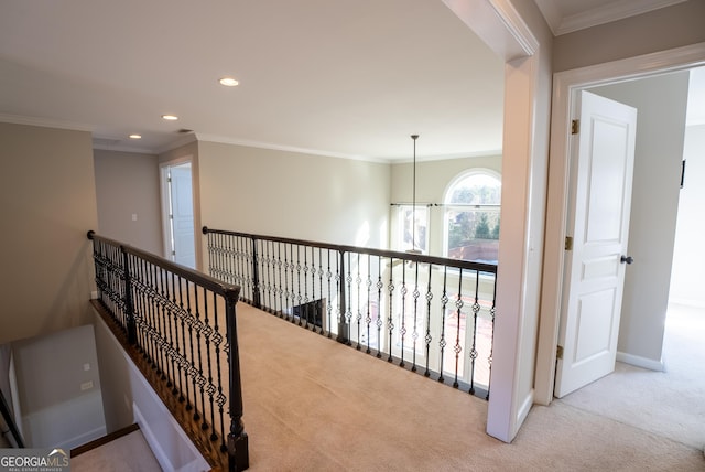 hallway with crown molding, light carpet, and a notable chandelier