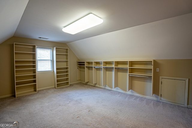 bonus room featuring lofted ceiling and light colored carpet