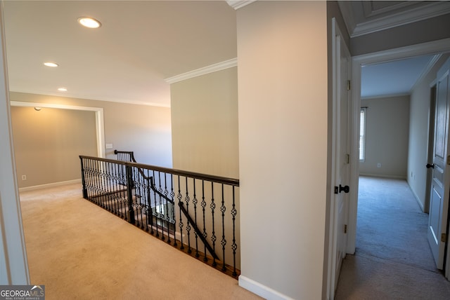 hallway with light carpet and crown molding