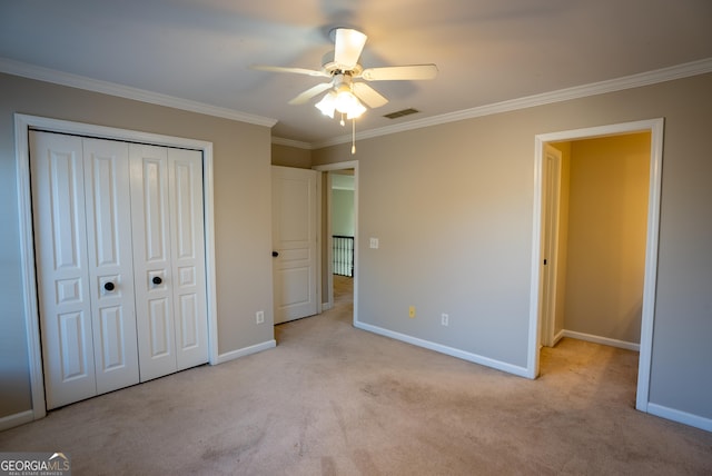 unfurnished bedroom with light carpet, ceiling fan, ornamental molding, and a closet