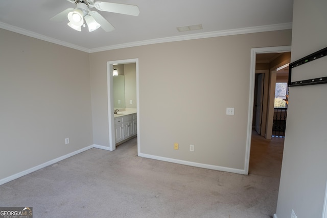 empty room featuring ceiling fan, light colored carpet, sink, and ornamental molding