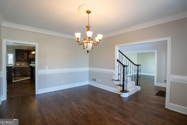 unfurnished room with an inviting chandelier, ornamental molding, and dark hardwood / wood-style flooring