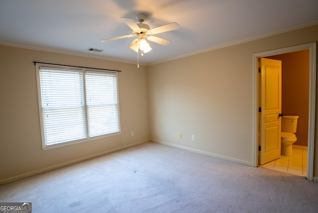 unfurnished room with ceiling fan, light carpet, and ornamental molding