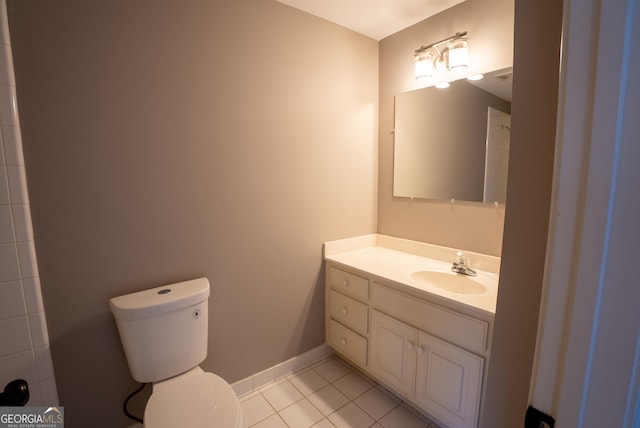 bathroom featuring tile patterned floors, vanity, and toilet