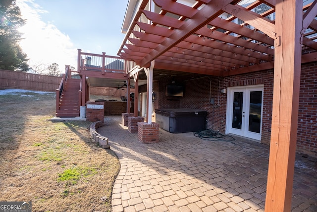 view of patio / terrace with a hot tub, french doors, and a pergola