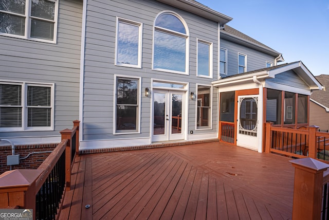 wooden terrace with a sunroom and french doors