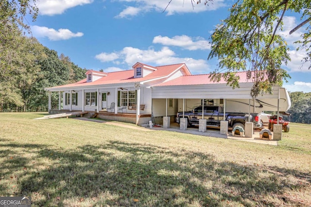 back of house with a lawn and a carport