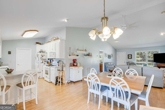 dining room featuring ceiling fan, vaulted ceiling, and light hardwood / wood-style floors