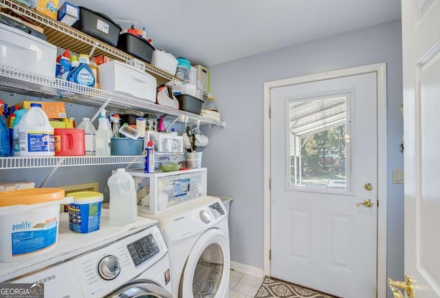 clothes washing area featuring washing machine and dryer and light tile patterned flooring