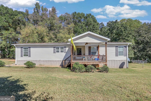 view of front facade with a front yard and covered porch