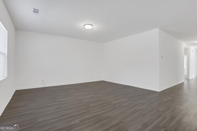 spare room with dark hardwood / wood-style floors