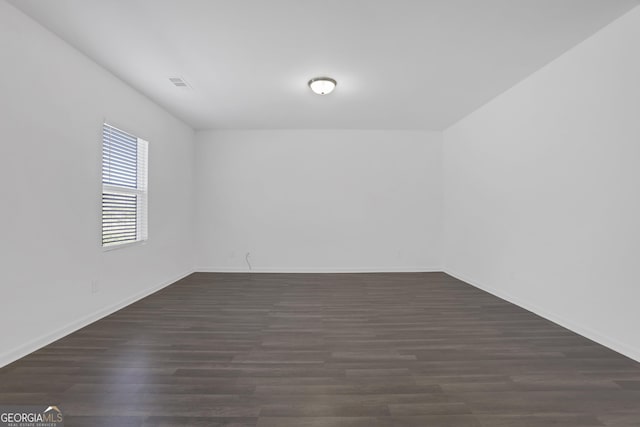 empty room featuring dark hardwood / wood-style flooring