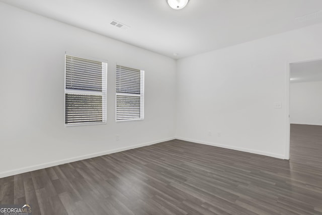 spare room with dark hardwood / wood-style flooring