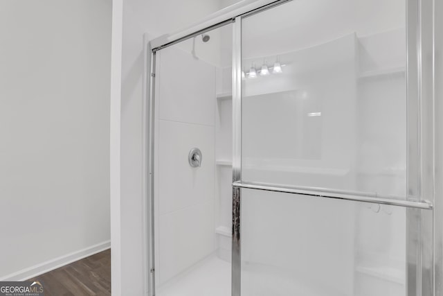 bathroom featuring wood-type flooring and walk in shower