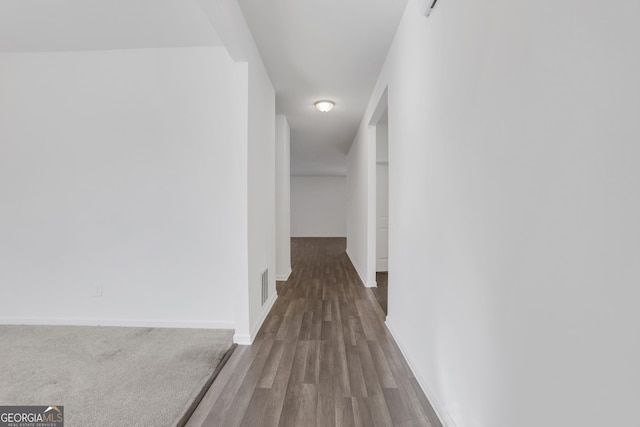 corridor with wood-type flooring