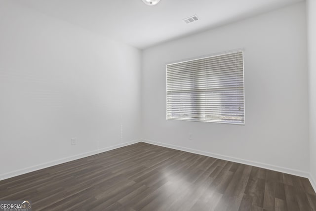 unfurnished room featuring dark hardwood / wood-style flooring