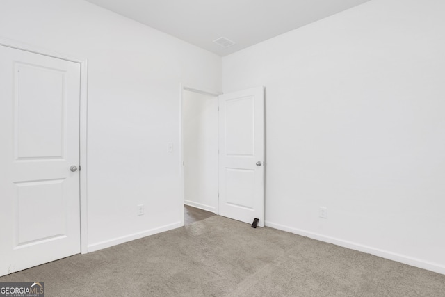 unfurnished bedroom featuring light carpet